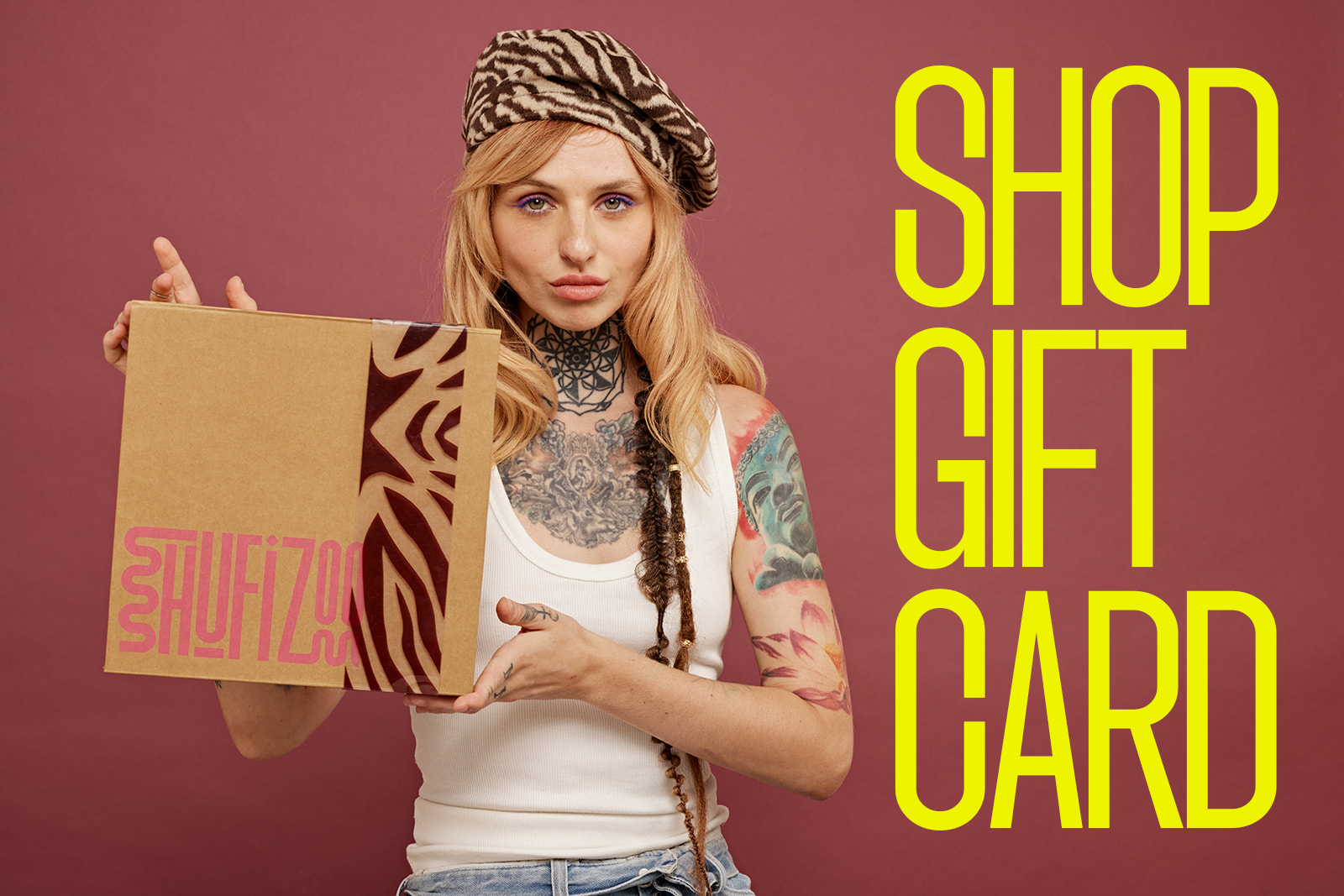 Model with hat and dreadlocks hold Shufizoo Box and "SHOP GIFT CARD" text next to her
